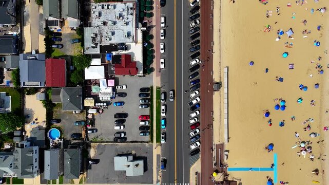 Aerial top-down shot of Belmar Beach and bustling boardwalk on a sunny day