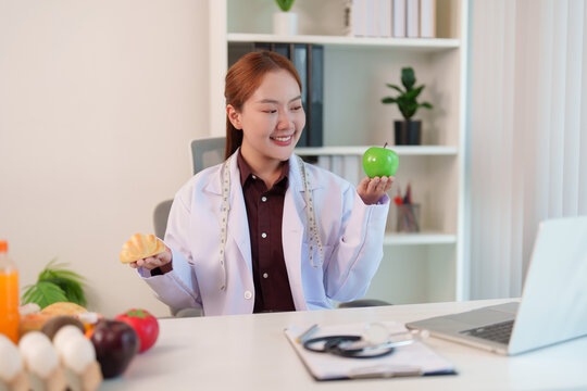 Asian female nutrition consultant giving online diet consultation on laptop