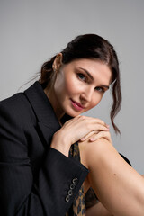 Fototapeta premium Young beautiful woman exudes elegance in chic attire while posing gracefully