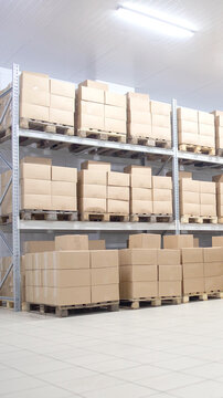 Industrial warehouse interior filled with rows of metal shelving holding stacks of cardboard boxes on wooden pallets, bright fluorescent lighting illuminating large storage facility vertical photo
