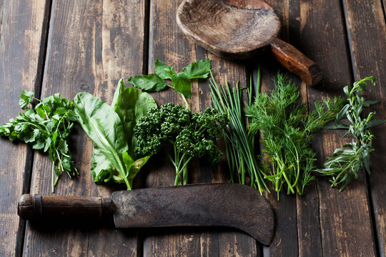 Ingredients of Frankfurt green sauce, old cleaver and wooden spoon