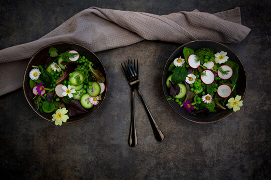Fresh spring salad with edible flower and radish from directly above
