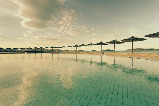 Croatia, Sibenik, Sunshades, Swimming pool of a hotel facility, Evening mood