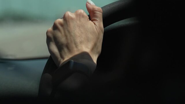 Safe Driving, Womans Hand Gripping Steering Wheel In Sunlight Vertical video