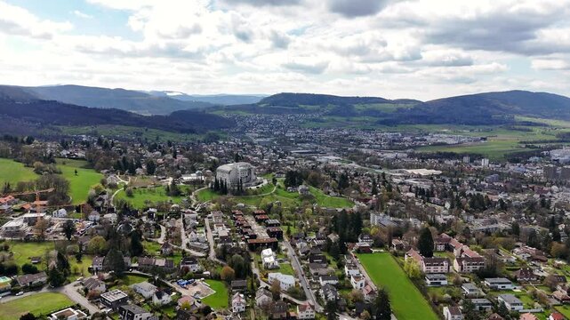 Goetheanum overlooking Dornach-Arlesheim, Solothurn and Basel-Landschaft, Switzerland, revealing the landmark building, residential districts and the Birs Valley, drone forward flyover.