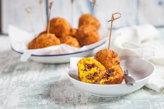 Arancini stuffed with tomato, mincemeat and mozzarella