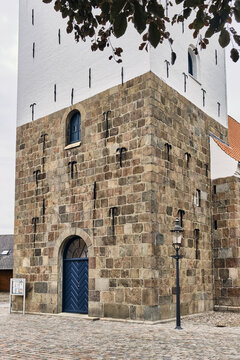 Varde, Syddanmark, Denmark - 31 July 2026: View of St. Jacobi Kirke featuring its historic 15th-century granite block tower and blue entrance door.