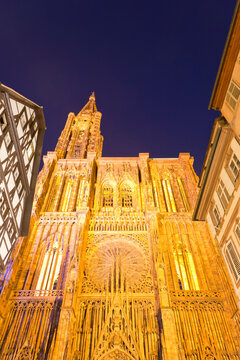 France, Alsace, Strasbourg, View of Notre Dame cathedral and frame houses at night