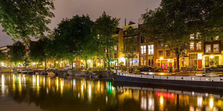 Netherlands, Amsterdam, row of lighted houses in the old town