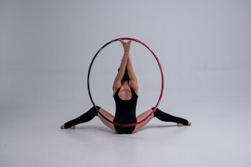 a gymnast sits with a hoop © Svetlana