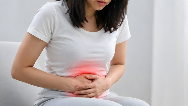 Woman suffering from abdominal pain, stomach ache, or menstrual cramps