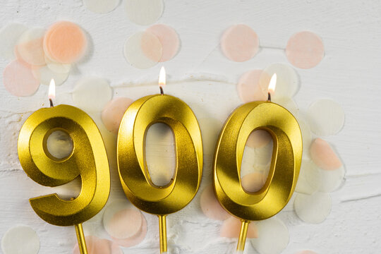 900 followers or subscribers. card golden birthday candle nine hundred on confetti background. Template for social networks, community fans.