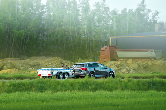Car pulling a covered trailer on road