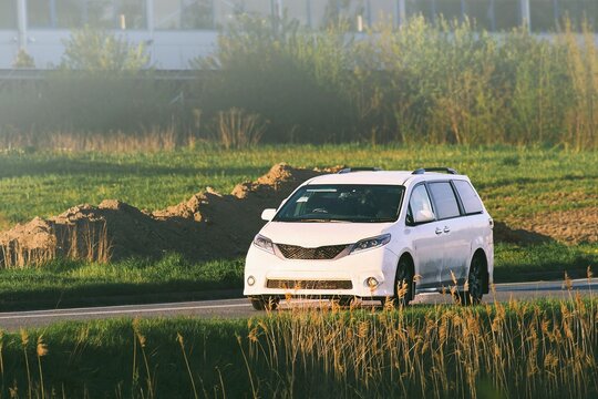 Electric car in motion across natural landscape