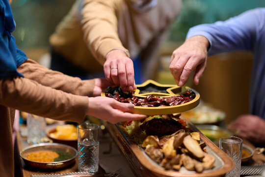 Family Sharing Dates and Food at a Warm Festive Meal Gathering