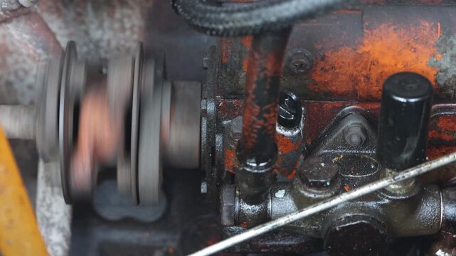 Close-up of a greasy and rusty diesel engine on a public river boat