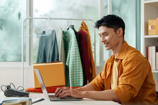 Asian entrepreneur using laptop for e-commerce small business management and AI technology