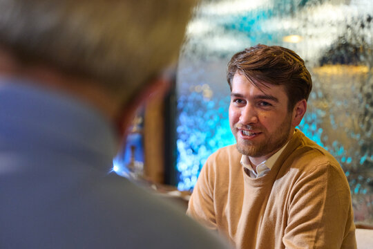 Casual Business Conversation Between Colleagues In Cozy Office Cafe During Informal Meeting