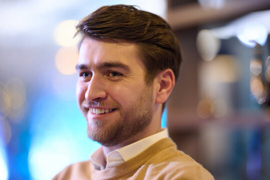 Smiling Young Man Portrait With Warm Bokeh Lighting Casual Beard And Relaxed Expression Indoors