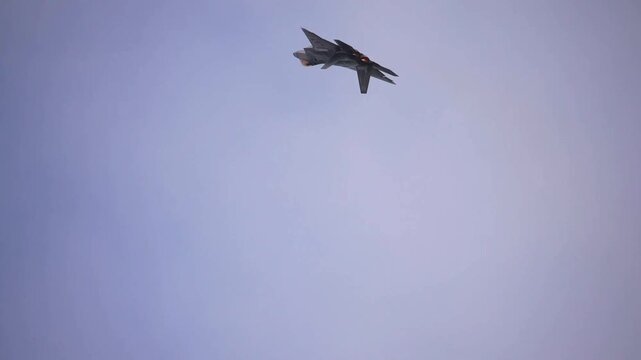 Stealth Fighter Aircraft Performing High-Speed Maneuver Through Clear Skies During Advanced Air Combat Training Mission.
