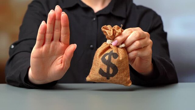Stop hand gesture and dollar money bag. No approve of the transaction or loan. Financial difficulties. Asset freeze seizure. Economic sanctions, confiscation of funds.