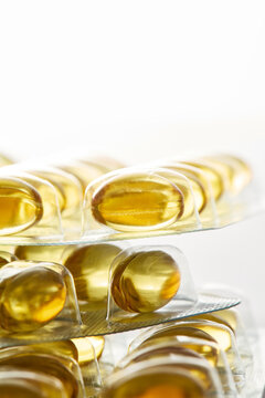 Stacked blister packs of golden fish oil capsules