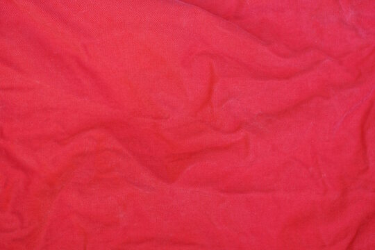 red texture from a piece of crumpled fabric on old clothes