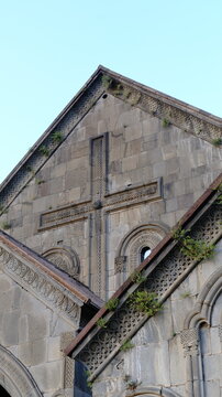 Carved stone cross relief and decorative stone facade of historic ancient Akhtala Monastery in Lori Province, Armenia