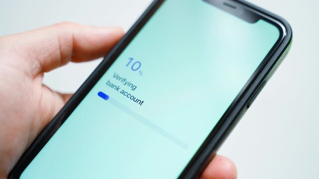Hand holding smartphone verifying bank account and showing verification failed error