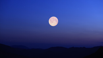 Full Moon, stars and planets above landscape silhouettes. © astrosystem