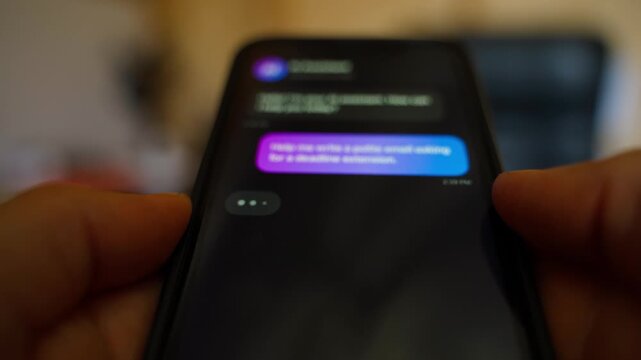 Hands holding smartphone asking AI assistant to write polite email about deadline extension
