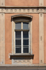 Fototapeta premium An elegant window on an old historicist building facade with vertical lines and stone geometric ornaments in Zagreb Croatia.