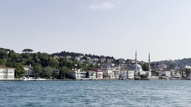 Scenic view of the historic Vanikoy Mosque and traditional waterfront mansions Yali on the Bosporus strait coastline in Istanbul, Turkey