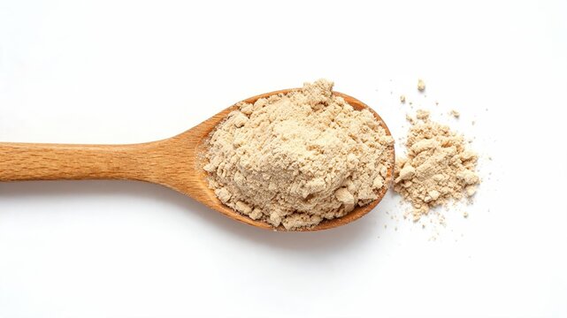Maca root herbal powder on wooden spoon on white