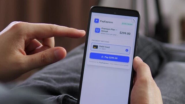 Customer prepares a secure annual subscription payment on a smartphone, reflecting the growth of recurring billing, digital services and cashless consumer habits.