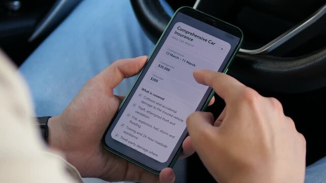 Driver reviews a digital car insurance policy on a smartphone, checking coverage, exclusions and claim rules as mobile insurance services reshape everyday vehicle protection.