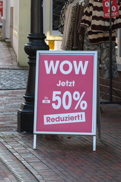 German sidewalk sign announcing 50 percent off sale