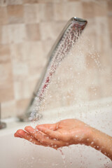 Fototapeta premium Hand catching fresh water from shower