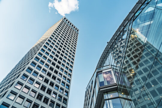View of modern glass skyscrapers reaching towards a clear blue sky in the financial district of London, England, United Kingdom.