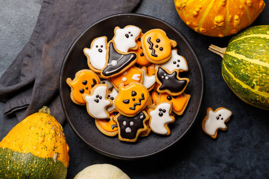Halloween cookies on black stone background with copy space
