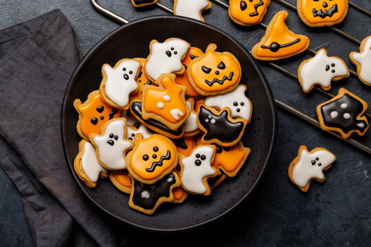 Halloween cookies on black stone background with copy space