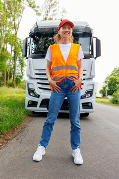 Portrait young adult happy smiling woman heavy truck driver modern cargo vehicle cabin background. Female person girl professional job career working driving freight engine lorry. Logistics industry