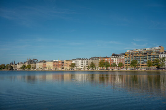 Scenic City Skyline and Architectural Facades Reflected on Lake Water