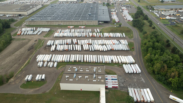Aerial view of Meijer Distribution Center DC 93 featuring a large warehouse facility surrounded by rows of parked semi-trailers and industrial yard space in Lansing, Michigan, United States.