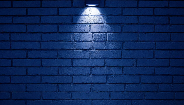 A dark blue brick wall background illuminated by a single spotlight shining from above the texture