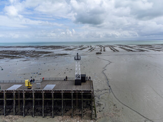 Aerial drone view of underwater oyster farms in Cancale, Brittany, exposed during low tide, raditional sustainable aquaculture and production of premium French oysters, France © barmalini