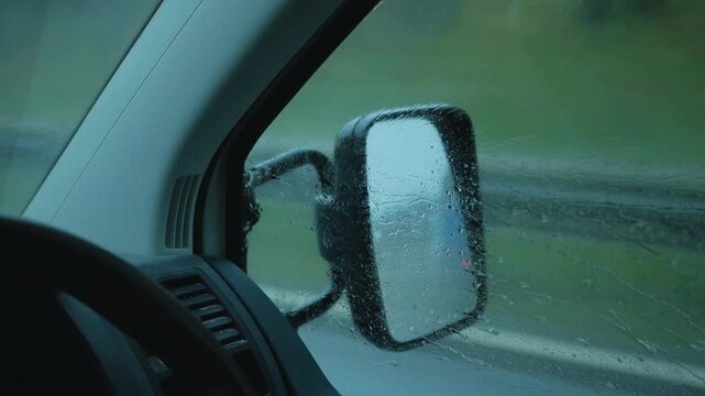 Rainy Weather Viewed Through truck Window with Reflections and Blurred City Lights