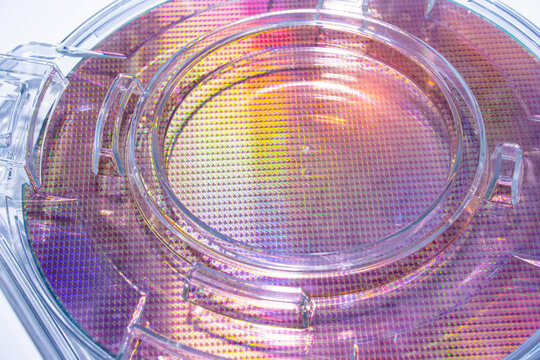 patterned silicon wafers in plastic holder box. Electronic circuit designs have been built onto the wafers using micromaching including photolithography