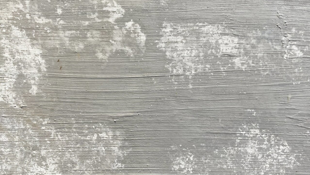 Weathered grey wood background with faded white paint splatters