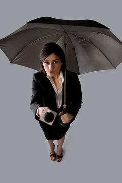 Portrait of beautiful woman with umbrella asking comment 